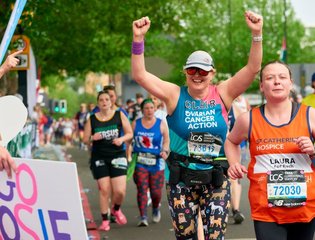 Claire running the London Marathon route in an Ovarian Cancer Action T shirt